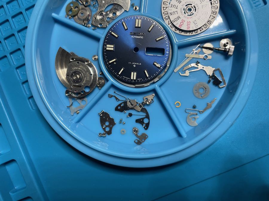 Mechanical watch movement being repaired